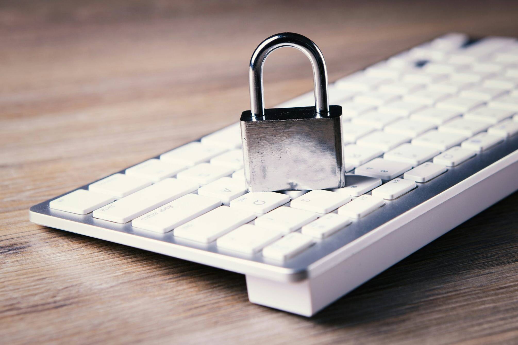 a computer keyboard with a padlock on top of it